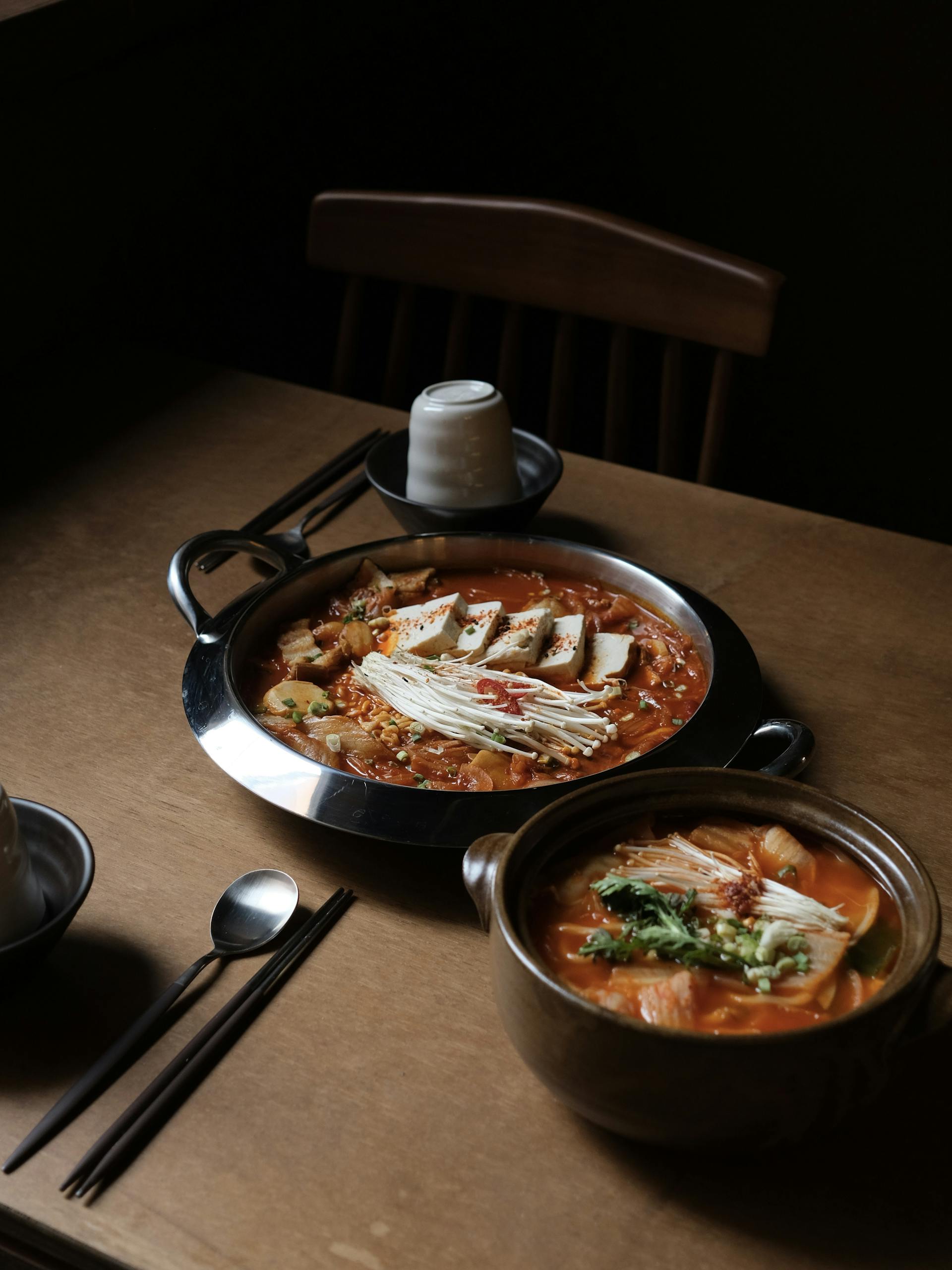 Home 22 Savory Korean hot pot with tofu, mushrooms, and vegetables, perfect for a cozy meal.